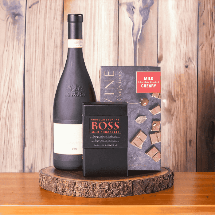Chocolate Cherries & Wine Gift Board features: BOSS Milk Chocolate, Bottle of Wine, Devine Confection Milk Chocolate Cherries, Live Edge Serving Board
