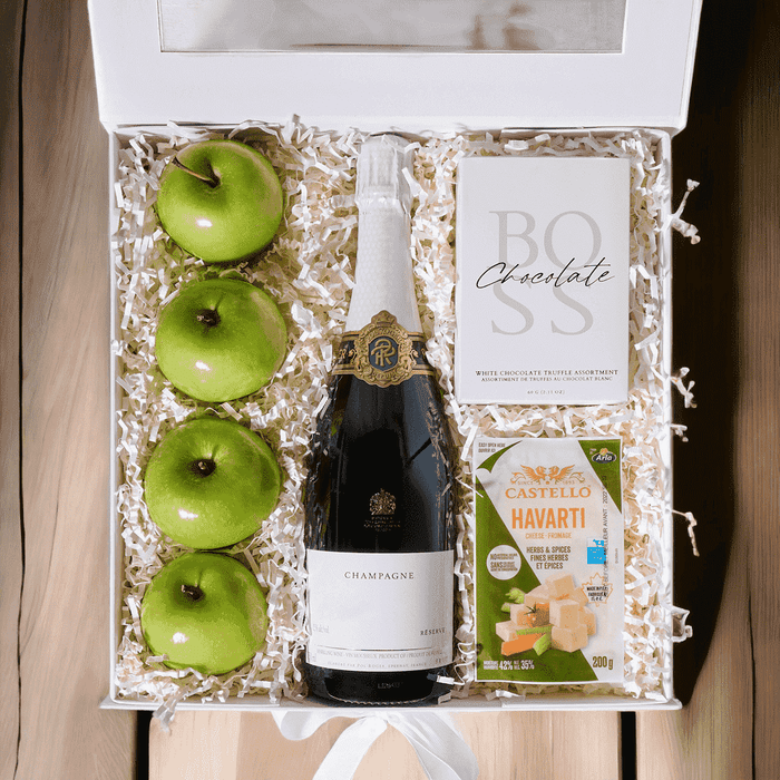 Apples & Cheese Gift Box with Sparkling Wine features Fuit, Chocolate, Castello Herbs & Spices Havarti Cheese, and a Large White Hinged Box.
