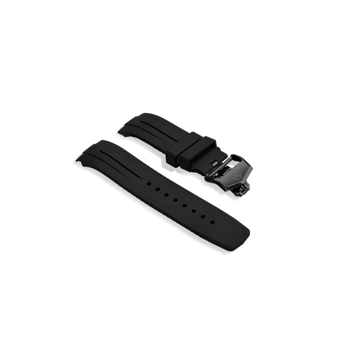 Flat lay of Golden Concept black rubber watch strap with textured surface, adjustment holes, and stainless steel folding butterfly clasp engraved with the Golden Concept logo