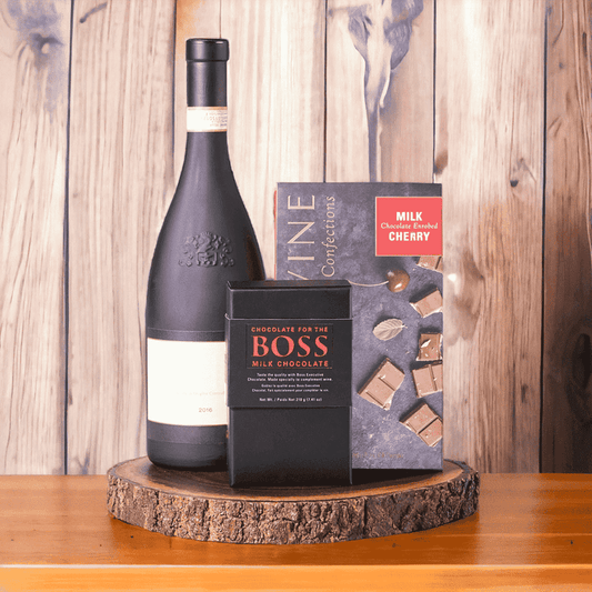 Chocolate Cherries & Wine Gift Board features: BOSS Milk Chocolate, Bottle of Wine, Devine Confection Milk Chocolate Cherries, Live Edge Serving Board