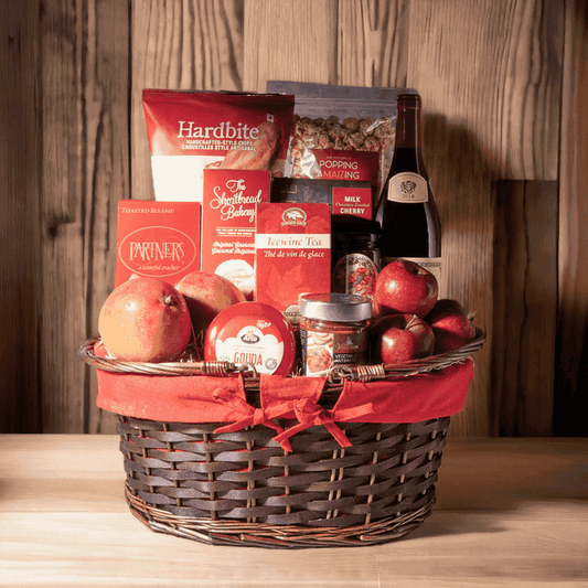 "Filled with Fun" Wine Gift Basket includes: 2 Mangoes, 3 Red Delicioud Apples, Greaves Pure Cherry Jam, Venetian Vegetable Antipasto, Arla Gouda Cheese, Divine Confections Milk Chocolate Cherries, Canada True Ice-wine Black Tea, Bottle of Wine, The Shortbread Bakery Original Gourmet, Hardbite Sweet Spud of Mine Chips, Popping Amaizing Popcorn, Partners Toasted Sesame Tasteful Cracker, and Oval Wicker Basket with Double Handles and Red Liner.