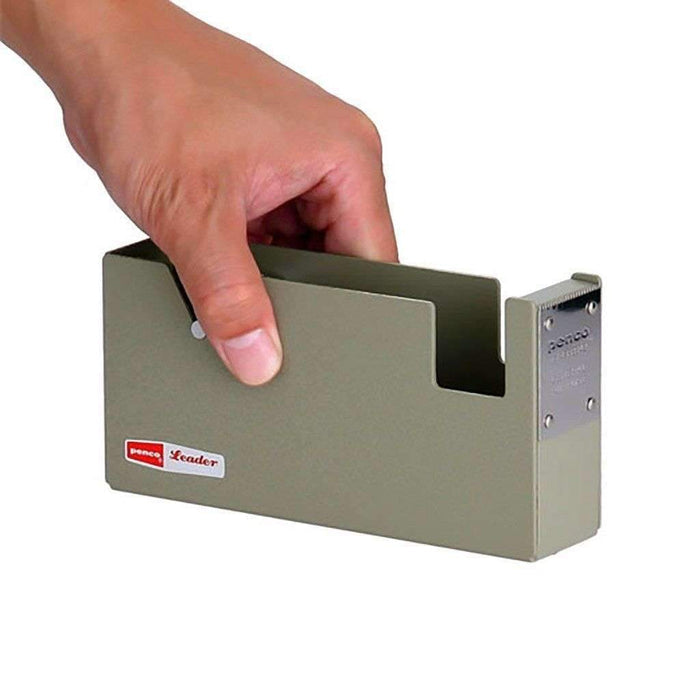 Hand holding a metal tape dispenser with a red Penco logo on a white background