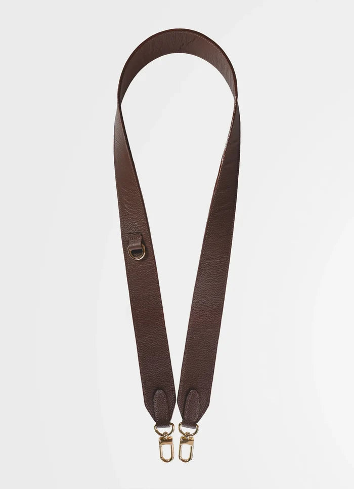 Brown leather strap with gold hardware on a light gray background