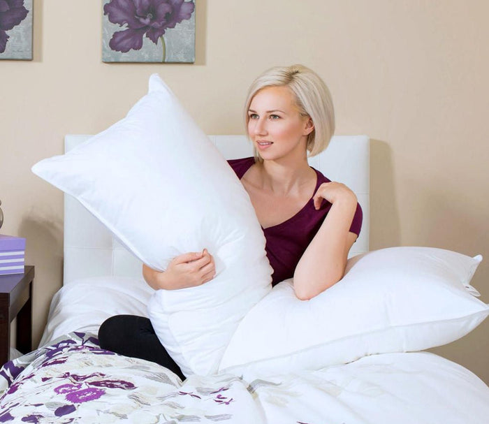 Night Song Down Alternative Body Pillow by City Mattress, model holding pillow